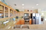 This high-end kitchen is fully equipped to prepare a gourmet meal.